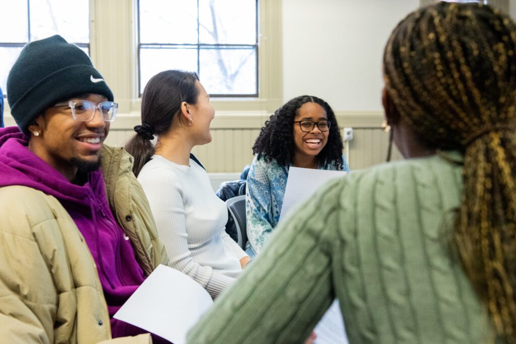 Harvard students in a classroom participating in an activity