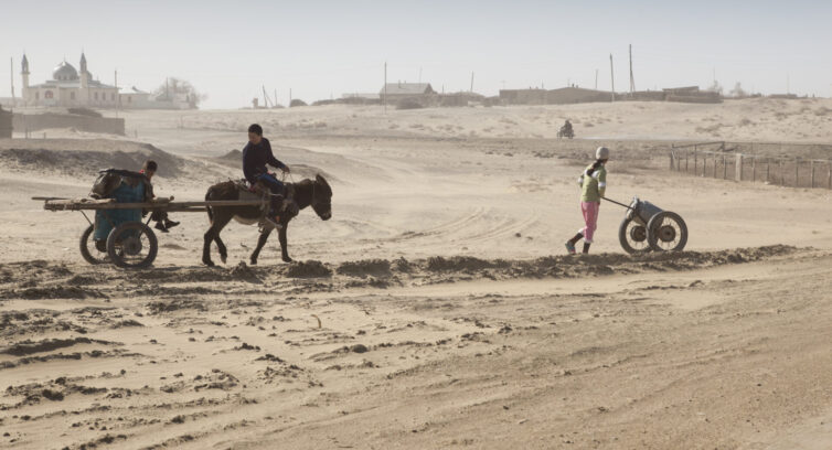 Children collecting water in the desert