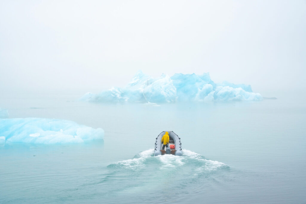 scientists on boat study the melting of icebergs due to global warming