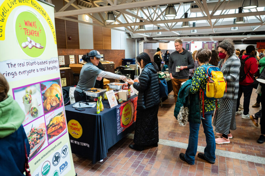 a food vendor hands out samples during the food 4 thought food expo