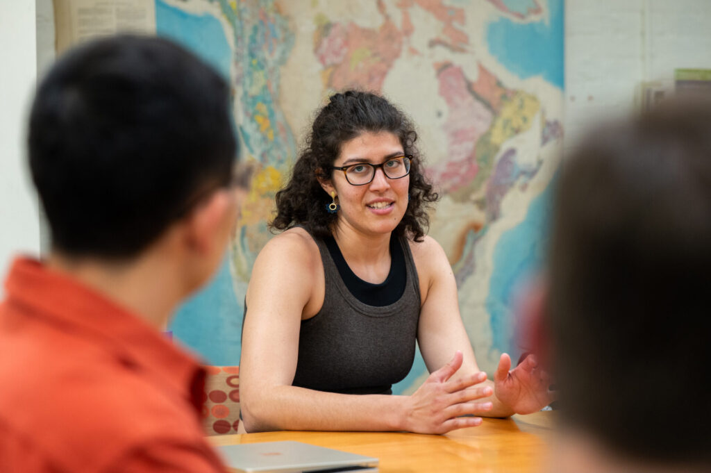 A female student talks while seated at an EGEE round table session