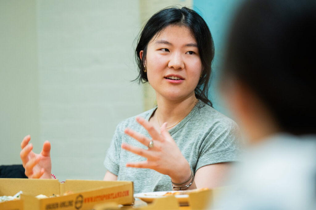 A female student talks while seated at an EGEE round table session