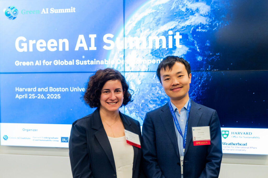 student organizer-leaders stand for a photo in front of the Green AI summit's holding slide 