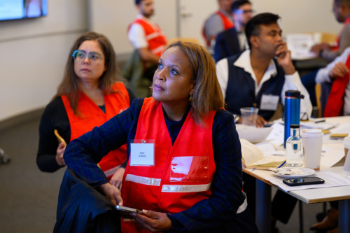 participants in vests at tables