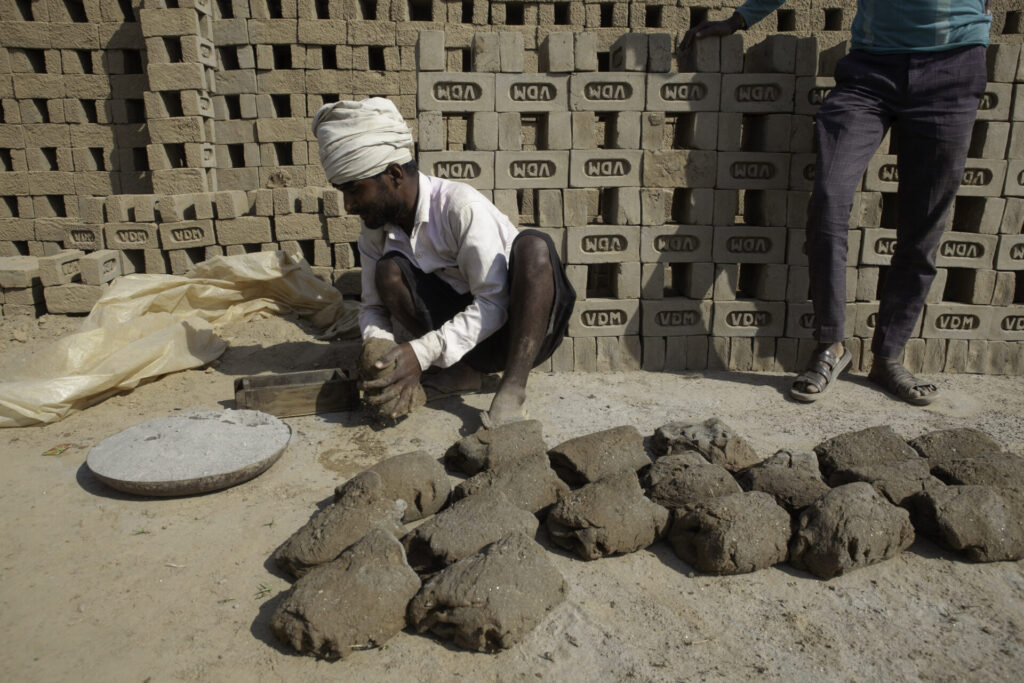 Man making bricks in India