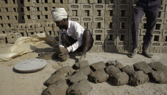Man making bricks in India