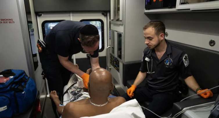 A man being treated in an ambulance
