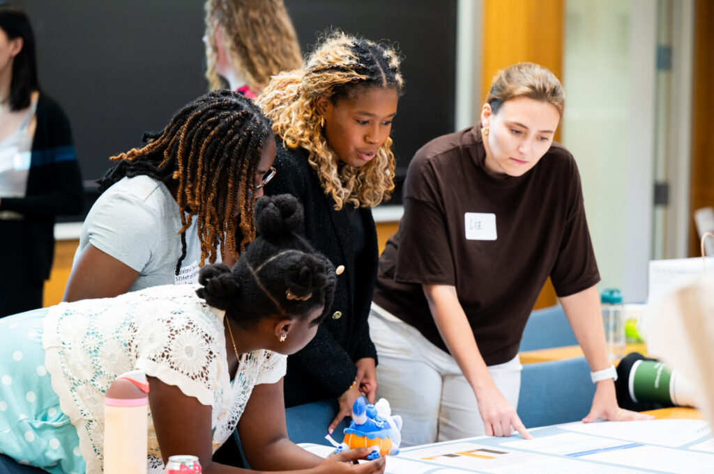 Students discuss poster during Salata Institute summer research funding program event